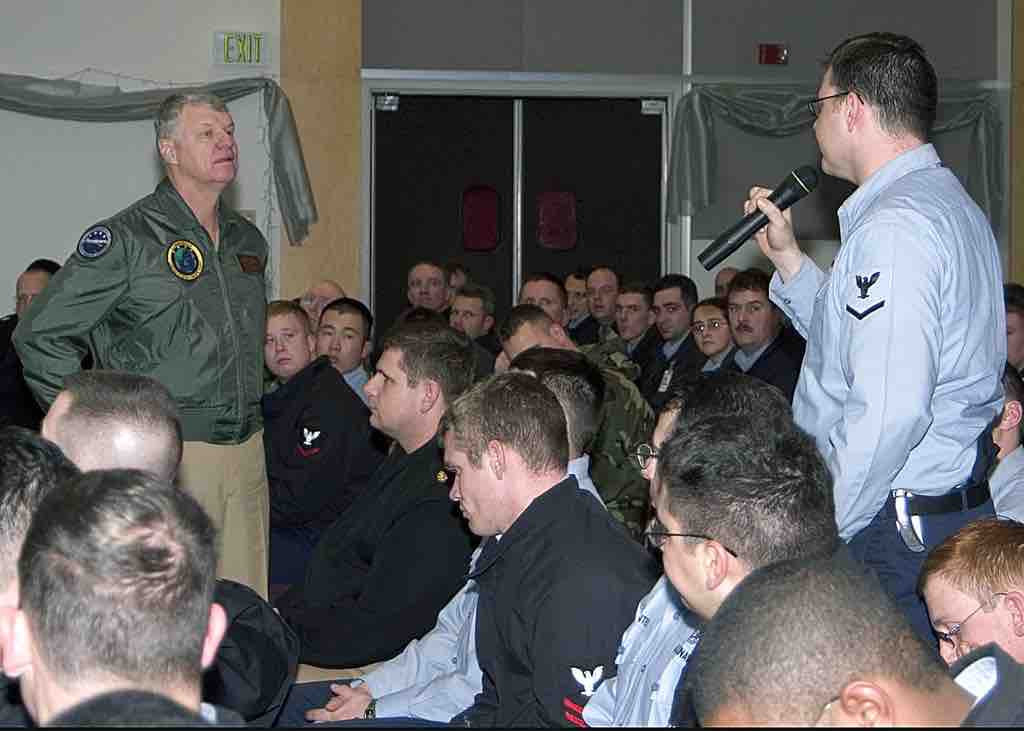 Damage Controlman 3rd Class Mark Gorley address a question to Adm. Gary Roughead