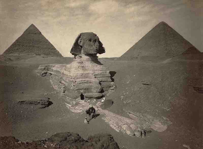 Albumen print of the Sphinx of Giza, partially excavated, with two pyramids in background