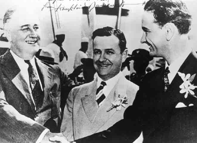 
Franklin Delano Roosevelt shakes hands with young Lyndon B. Johnson, Gov. James Allred of Texas in between. Galveston, Texas on May 12, 1937,
Franklin D. Roosevelt

 