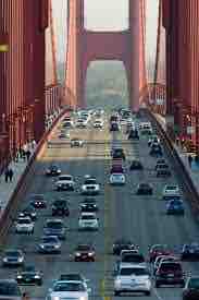 Cars entering and leaving a city over a bridge