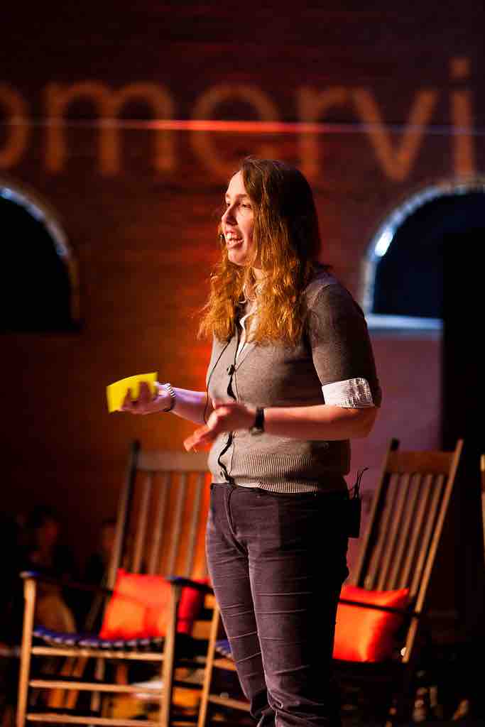 A woman delivers a speech at a TEDx event.