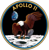 Circular insignia: eagle with wings outstretched holds olive branch on moon with earth in background, in blue and gold border.