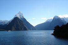 Blue water against a backdrop of snow capped mountains