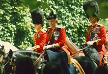 Elizabeth in red uniform on a black horse