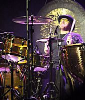 A colour photograph of Jason Bonham playing drums