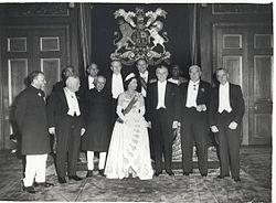 A formal group of Elizabeth in tiara and evening dress with eleven prime ministers in evening dress or national costume.